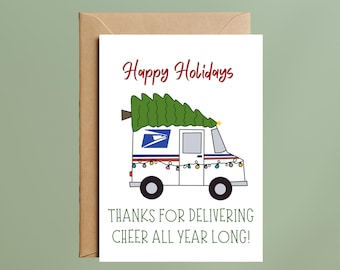 May include: A white greeting card featuring a cartoon mail truck with a green Christmas tree on its roof, decorated with colorful string lights. The text reads Happy Holidays and THANKS FOR DELIVERING CHEER ALL YEAR LONG! A brown envelope is behind the card.