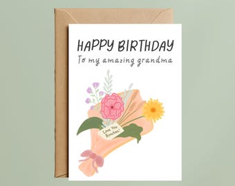 May include: A birthday greeting card with the text "HAPPY BIRTHDAY To my amazing grandma." The card features a bouquet of pink, yellow, and purple flowers wrapped in peach paper. A small tag reads "Love You Bunches!" The card is inside a brown envelope.