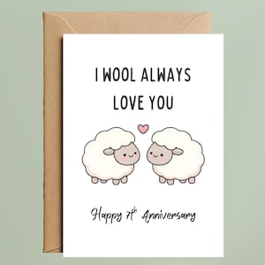 May include: A white greeting card with the text "I WOOL ALWAYS LOVE YOU" and "Happy 7th Anniversary". The card features two cartoon sheep with a pink heart between them. The card is inside a brown envelope.