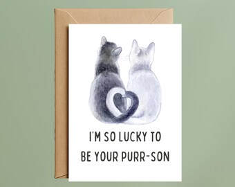 May include: A white greeting card with a watercolor illustration of a grey cat and a white cat sitting side by side with their tails intertwined to form a heart shape. Below the cats, the text reads: I'M SO LUCKY TO BE YOUR PURR-SON.