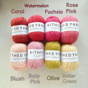 May include: Eight skeins of KITHED YARN arranged in two rows. Top row colours: Coral, Watermelon, Fuchsia, and Rose Pink. Bottom row colours: Blush, Baby Pink, Olive, and Butter Cream. Each skein features a white paper label with the brand name.