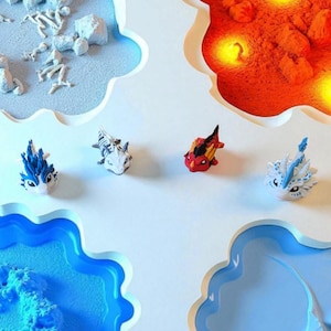 May include: Four small, colorful dragon figurines are displayed against a white background with cloud-shaped cutouts. The dragons are blue, red, and white, with intricate details. The scene evokes a fantasy theme.