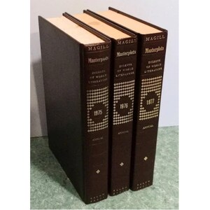 May include: Three brown hardcover books titled "Magill's Masterplots" with gold lettering. The books are arranged from left to right with the years 1975, 1976, and 1977 on the spines. Each book is labeled "Digests of World Literature" and "Annual".