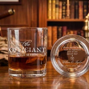 May include: A clear glass tumbler with the text "the OFFICIANT KYLE MASON" filled with amber liquid. Beside it, a second glass with the text "Thank you for being such an important part of our special day!" and the names "William & Sophia".