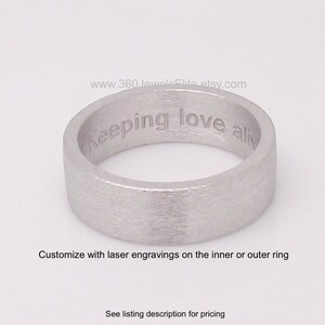 May include: A silver ring with a brushed finish and the inscription "Keeping love alive" engraved on the inside.