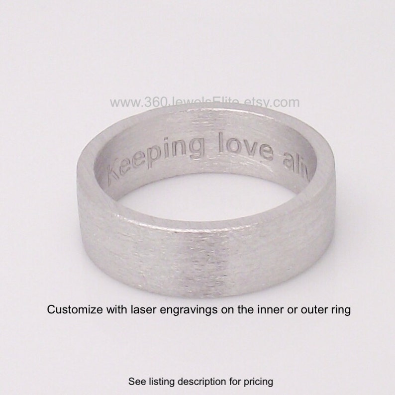 May include: A silver ring with a brushed finish and the inscription "Keeping love alive" engraved on the inside.