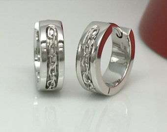 May include: A pair of silver hoop earrings with a chain design. The earrings are made of metal and have a polished finish.