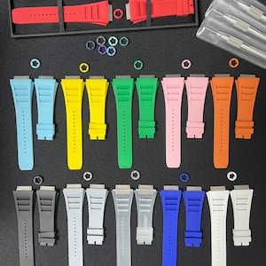 May include: A collection of 12 different colored watch bands, each with a unique design. The bands are made of a durable material and are available in a variety of colors, including red, blue, green, yellow, and black.