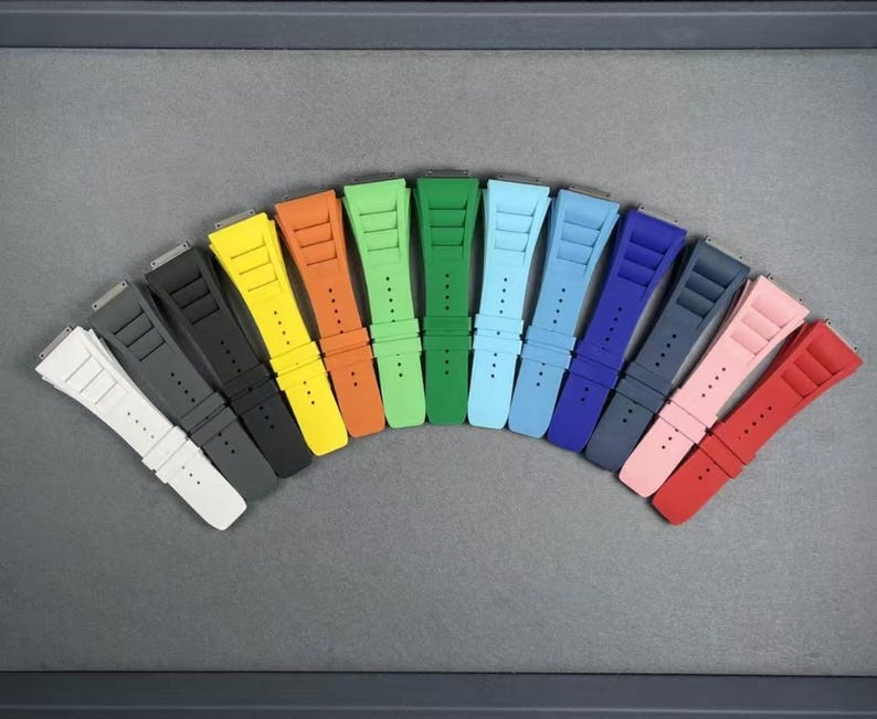 May include: A set of 12 colorful watch bands in various shades of blue, green, yellow, red, and pink. The bands are made of a durable, flexible material and are designed to fit most standard watch sizes.