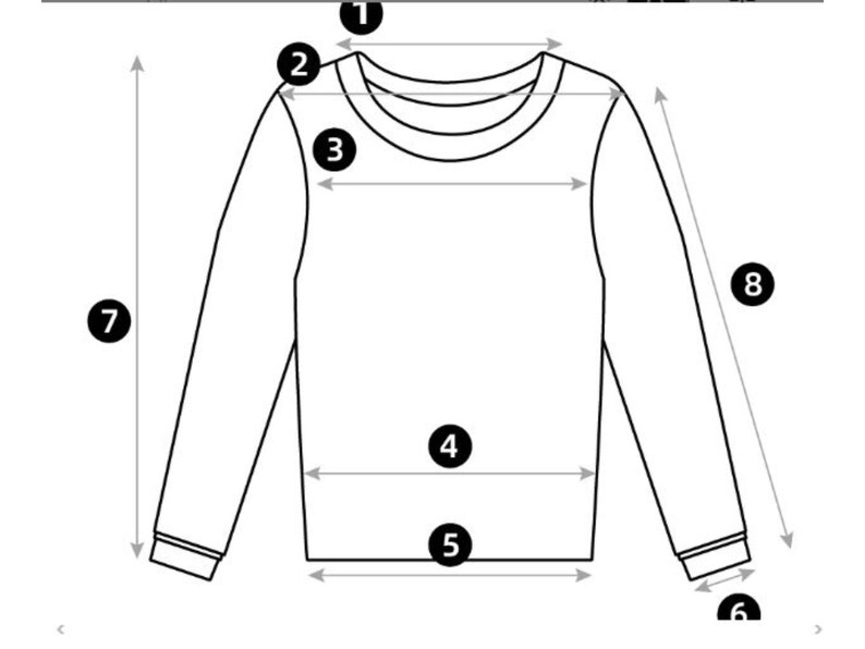 May include: Diagram of a long-sleeved shirt with measurements indicated. The illustration shows the neckline, shoulder width, chest width, waist width, sleeve length, and cuff width. The shirt is depicted in a simple black and white style.
