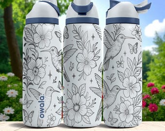 May include: Three white water bottles with a dark blue lid and handle, featuring a gray line-art pattern of hummingbirds, butterflies, flowers, and small stars. The word Owala is printed vertically in dark blue on the left bottle.