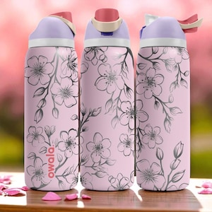 May include: Three pink water bottles with a floral design. The bottles have a light purple lid and a pink and white flip-top. The bottles are decorated with a grey floral pattern and the word "owala".