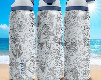 May include: Three white water bottles with a blue and white lid. The bottles have a detailed black and white ocean-themed design featuring sea creatures like sharks, jellyfish, and starfish. The word "owala" is printed on one bottle.