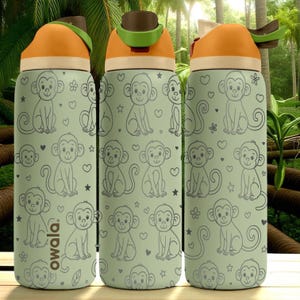 May include: Three water bottles with a light green background and a repeating pattern of cartoon monkeys, hearts, and stars. The bottles have orange lids and the brand name "owala" is printed on the side.