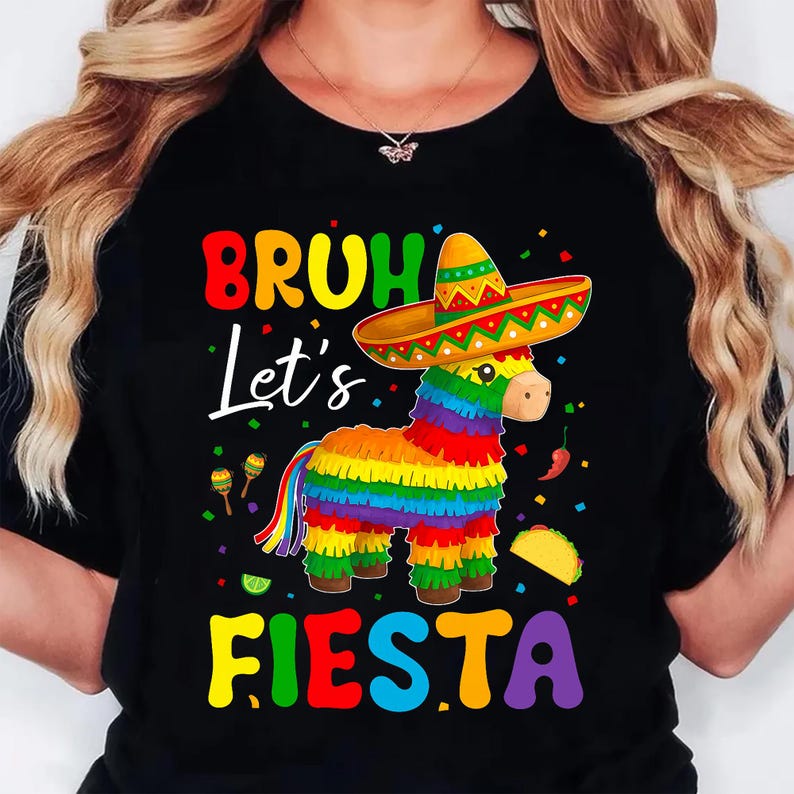 May include: Black t-shirt with a colorful graphic of a donkey pi&ntilde;ata wearing a sombrero. The text "BRUH Let's FIESTA" is displayed in bright, festive colors. Includes maracas, a taco, and chili peppers.