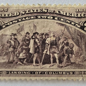 May include: A vintage United States postage stamp from 1892, featuring a sepia-toned illustration of Columbus's landing. The stamp reads "UNITED STATES OF AMERICA" and "POSTAGE TWO CENTS". The bottom of the stamp reads "LANDING OF COLUMBUS".