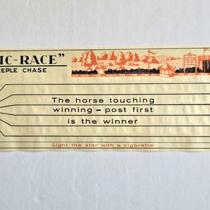 May include: Vintage "MYSTIC-RACE" steeple chase game card. The card features illustrations of horses, a racetrack, and text that reads "The horse touching winning-post first is the winner." Includes the text "Light the star with a cigarette."