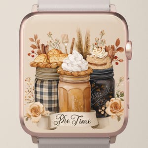 May include: A rose gold smartwatch displays a watercolor illustration of three mason jars filled with pie and topped with whipped cream. The jars are surrounded by wheat, cinnamon sticks, and flowers. A banner reads "Pie Time."
