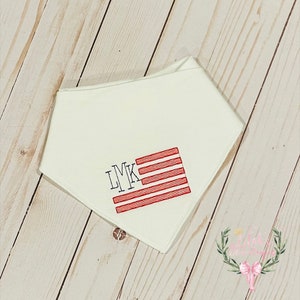 May include: White bandana with red and blue embroidered American flag and the letters LMK.