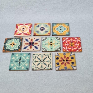 May include: Ten square wooden buttons with colorful tile patterns. The buttons have two holes each and are perfect for crafting projects.