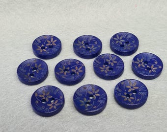 May include: Ten blue wooden buttons with a gold floral design. The buttons have two holes each.