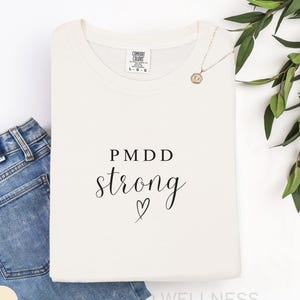 PMDD Strong Shirt | Comfort Colors Premenstrual Dysphoric Disorder Awareness T-Shirt | Support Gift Idea for PMDD Warrior, Advocacy Text Tee