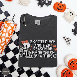 Hanging On By A Thread Shirt | Halloween Comfort Colors Spoonie Tee | Skeleton Chronic Illness Humor Tee for Fall Autumn, Spooky Season Gift