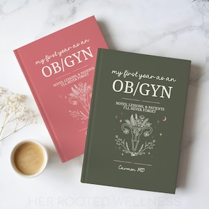 May include: Two hardcover journals are shown, one in a dusty rose hue and the other in olive green. The journals are inscribed with "my first year as an OB/GYN" and floral designs. The text "NOTES, LESSONS, & PATIENTS I'LL NEVER FORGET" is also present.