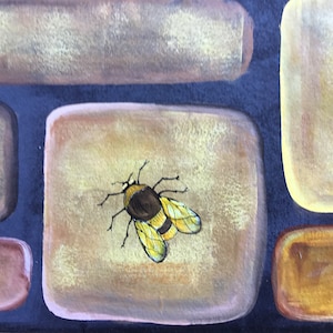 May include: A painted stone with a yellow and brown bee on it. The stone is part of a wall made of painted stones.
