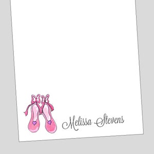 May include: Pink ballet shoe stationery with the name "Melissa Stevens" written in cursive.