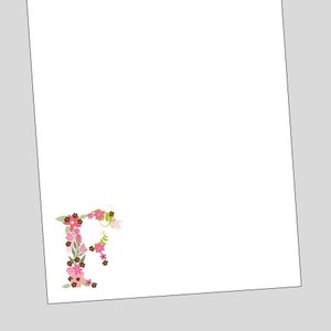 May include: A white background with a floral letter 'R' in pink, green, and brown.