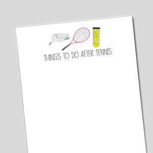 May include: A white notepad with the text "THINGS TO DO AFTER TENNIS" and watercolor illustrations of tennis equipment. The illustrations include a visor, a red tennis racket, and a can of tennis balls.