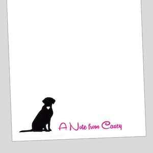 May include: A white notecard with a black silhouette of a dog sitting with a pink heart on its chest. The text "A Note from Casey" is written in pink cursive at the bottom of the card.