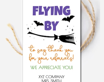 May include: A white card with a purple and black illustration of a witch flying on a broomstick with bats and stars. The text reads "Flying By to say thank you for your referrals! We appreciate you!"  XYZ Company, Mrs. Smith, 555.1212.