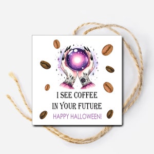 May include: A white card with a purple and pink illustration of a hand holding a crystal ball. The text on the card reads "I see coffee in your future. Happy Halloween!" and is surrounded by brown coffee beans.