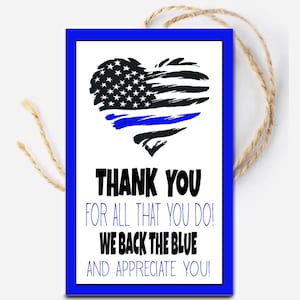 May include: A blue and white thank you card with a heart-shaped American flag with a blue line through it. The text on the card reads "Thank you for all that you do! We back the blue and appreciate you!"