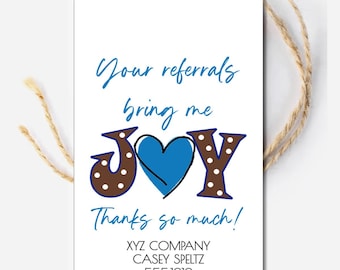 May include: White card with brown and white polka dots and a blue heart. The text reads "Your referrals bring me JOY Thanks so much!"  XYZ COMPANY CASEY SPELTZ 555.1212