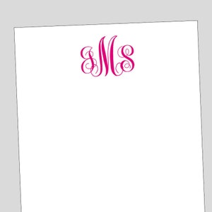 May include: A white notepad with a pink monogram of the letters "MS" in a cursive font.