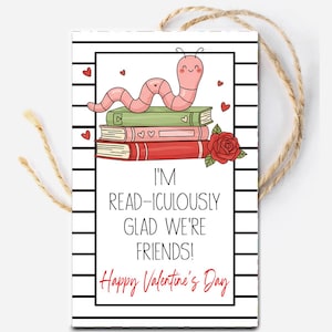 May include: A Valentine's Day gift tag with a cartoon worm on a stack of books, a rose, and hearts. The tag reads "I'M READ-ICULOUSLY GLAD WE'RE FRIENDS! Happy Valentine's Day" with a twine string for hanging. The tag has a black and white striped border.