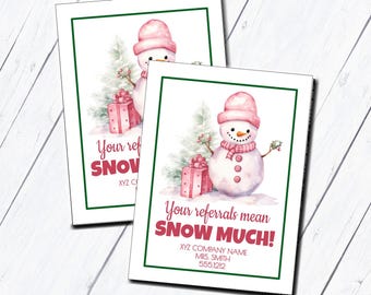 May include: A pink snowman with a red gift box and green pine branches. The text reads "Your referrals mean SNOW MUCH!" with a company name, contact name, and phone number.