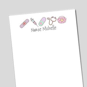May include: White stationery with a light gray border. The top of the stationery features a band-aid, syringe, pill, stethoscope, and nurse's cap in pastel colors. The text "Nurse Michelle" is written in gray cursive font.