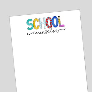May include: A white notepad with the text "SCHOOL counselor" in colorful letters. The letters are decorated with school supplies like pencils, rulers, and erasers.