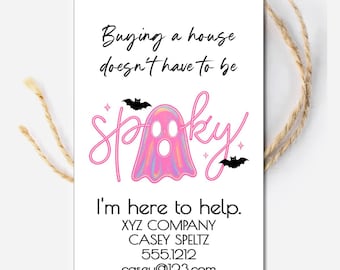May include: A white rectangular tag with the words "Buying a house doesn't have to be spooky" in black script. A pink ghost graphic is in the center, with the words "I'm here to help" below. Contact information is at the bottom.