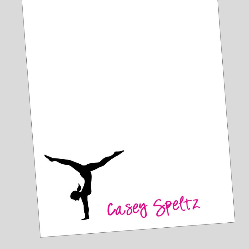 May include: Silhouette of a gymnast performing a handstand, with the name "Casey Speltz" written in pink below.