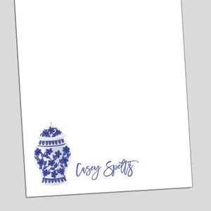 May include: Blue and white porcelain ginger jar with floral design. The text "Casey Spelts" is written in blue cursive below the jar.