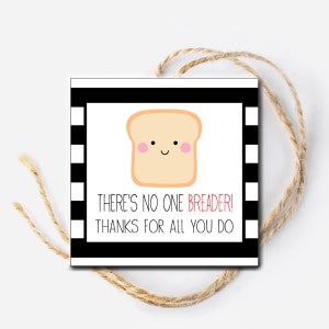 May include: A black and white striped card with a white bread cartoon with a smiling face and pink cheeks. The card says "There's no one breader! Thanks for all you do".