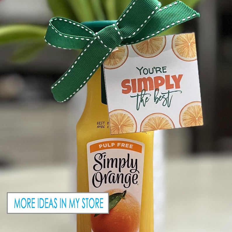 May include: A gift basket with a bottle of Simply Orange pulp-free juice and a gift tag that says "You're Simply the Best". The gift tag has a background of orange slices.