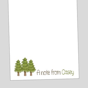 May include: A white notepad with a green border and three green trees at the bottom. The text "A note from Casey" is written in brown at the bottom of the notepad.