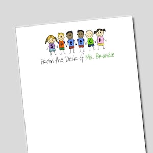 May include: A white notepad with a green line and the text "From the Desk of Ms. Brandie". Above the text is a line of stick figure children holding hands, each wearing a different colored shirt with a letter on it, spelling out the word "SPEECH".