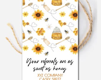 May include: A white gift tag with a watercolor design of sunflowers, honey pots, bees, and honeycomb. The text reads "Your referrals are as sweet as honey." Includes contact information. A natural twine string is attached.